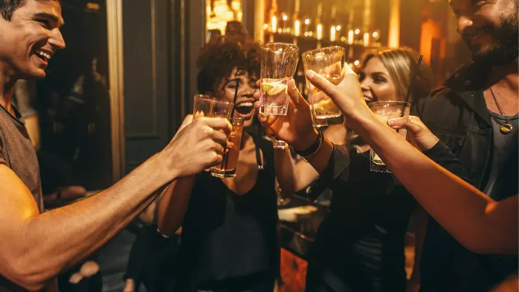 A group raising drinks together in a restaurant