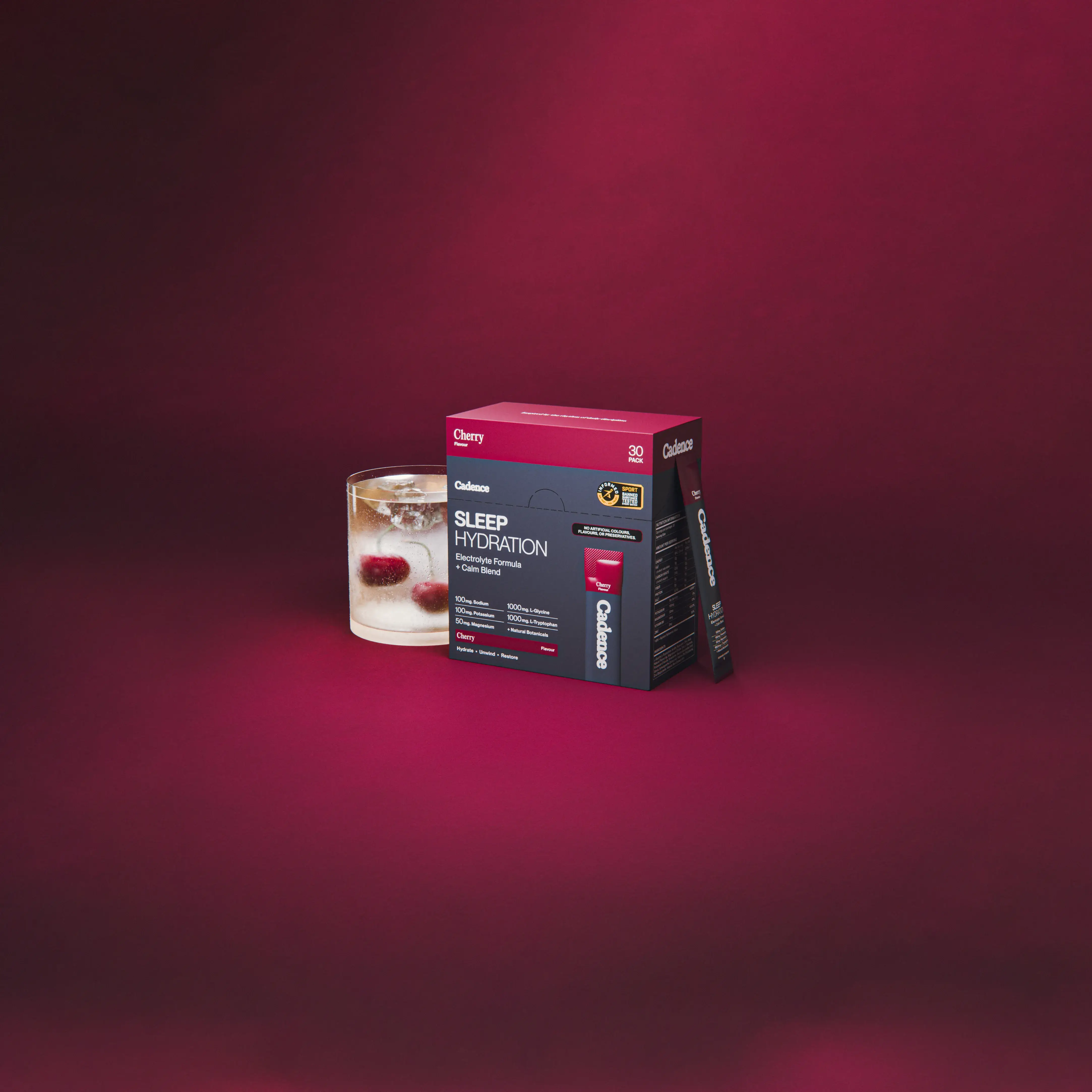 A Cadence Sleep Hydration box beside a filled glass on a deep pink ground